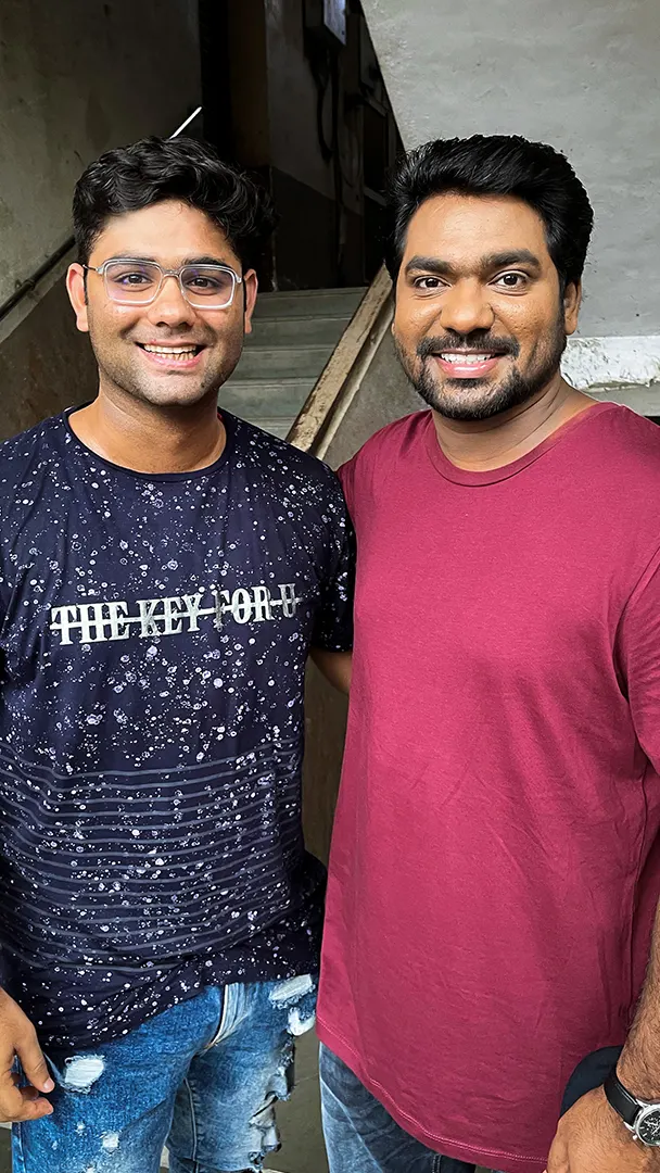 Ashu Gandhi with a collaborator indoors